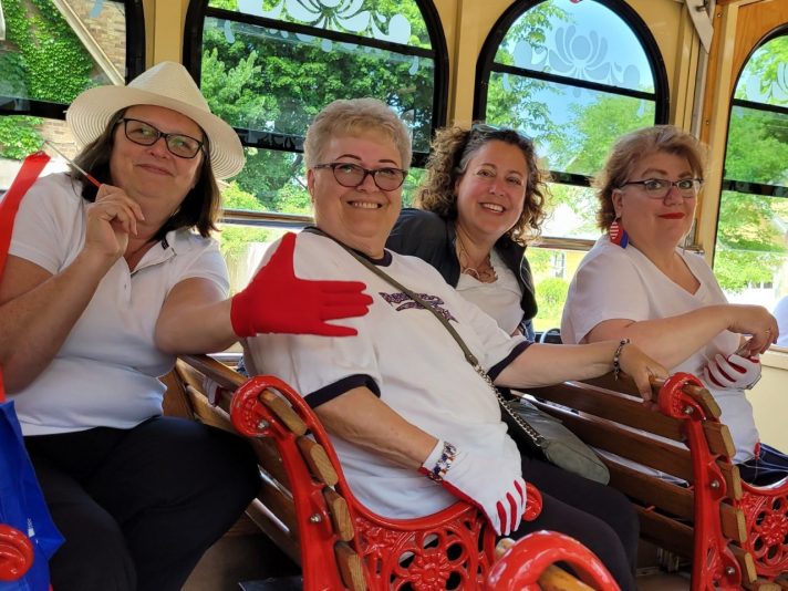 women in a trolly as a part of the Flag Day parade