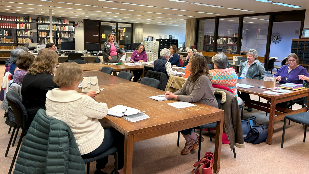women sitting around tables at a meeting