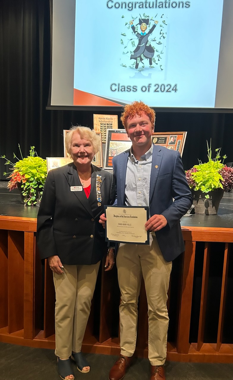 woman standing next to a student who won the DAR Good Citizens Award